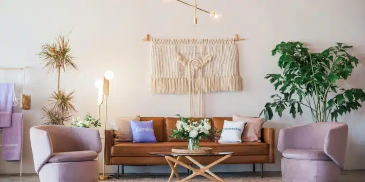 brown leather sofa and two pink sofa chair